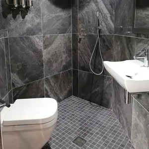 En-suite wetroom in Redhill Completed level-access wetroom installation with large format grey porcelain tiles in Redhill installed by Tom's Services