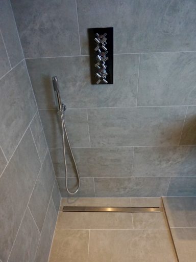 Wetroom in Clapham Modern wetroom with grey tiled walls installed by Tom's Services in Clapham