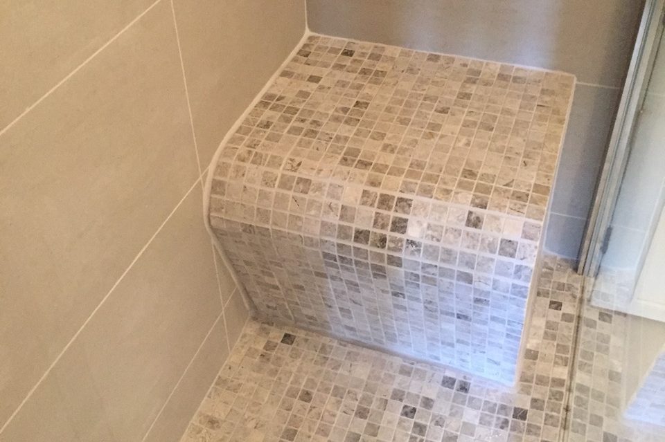Mobility upgrade wetroom Tiled wetroom shower corner with a built-in seating area by Tom's Services in Sutton